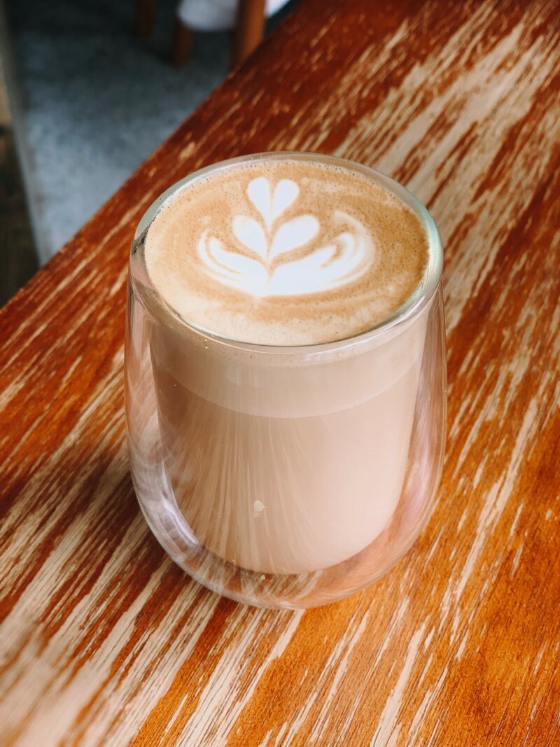 chai latte in a glass cup