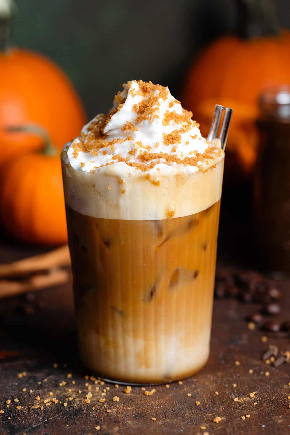 big glass of iced pumpkin latte with whipped cream